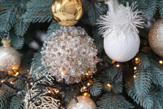 Christmas tree decorated with New Year garland and decor toys. Close up shot. High quality photo.