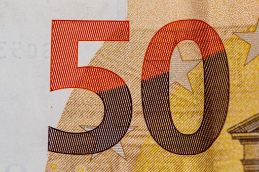 detail of the 50 euro banknote on a wooden surface