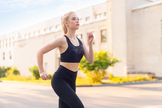 Sport and Fitness. Fit Woman Running City Street Summer Sunny Morning Caucasian Athletic Female Jogging Outdoor Cardio Training Active Healthy Lifestyle Dressed Black Sportswear Motivation Concept
