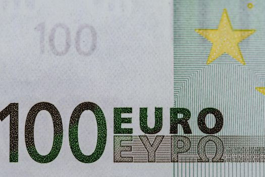 detail of 100 euro banknote on wooden surface