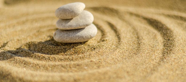 zen meditation stone in sand, concept for purity harmony and spirituality, spa wellness and yoga background, harmony