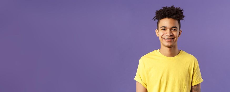 Close-up portrait of smiling, enthusiastic hispanic male student searching job, consider career opportunities, recruiting to company, smiling cheerful standing purple background.