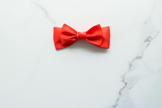 Holiday decor, feminine design and flatlay concept - Red silk ribbon on marble, top view