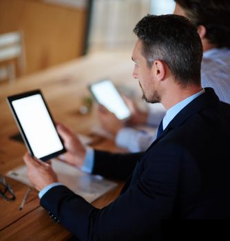 Integrating technology into conferences. businesspeople using their digital tablets during a conference