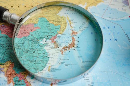 Bangkok, Thailand - May 15, 2022 Magnifying glass on world map.