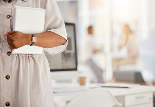Tablet, technology and internet with the hand of a business woman holding a wireless device in her office with colleagues in the background. Wifi, communication and networking with modern tech.