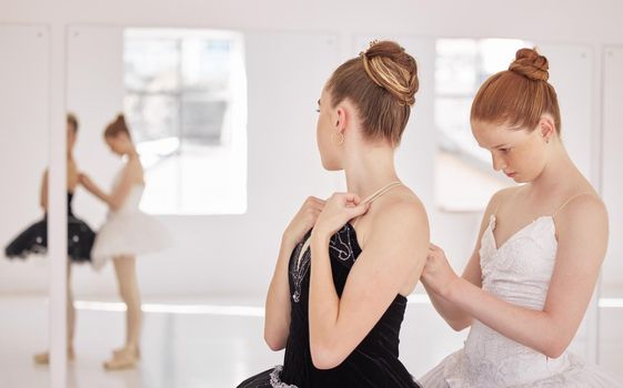 Ballet woman with help from girl with clothes before training, exercise or abstract dance routine. Ballerina student in studio for show with team or partner support at performance art academy school.