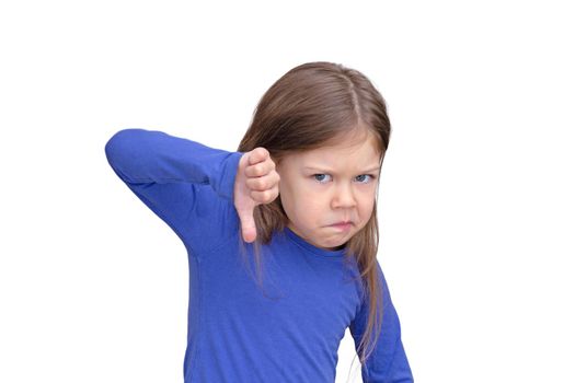 Kid holding thumb finger down with funny face on white background caucasian little girl of 5 years in blue waist up