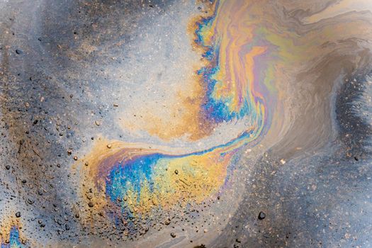 Color Gasoline fuel spots on Asphalt Road as Texture or Background. Environmental pollution concept