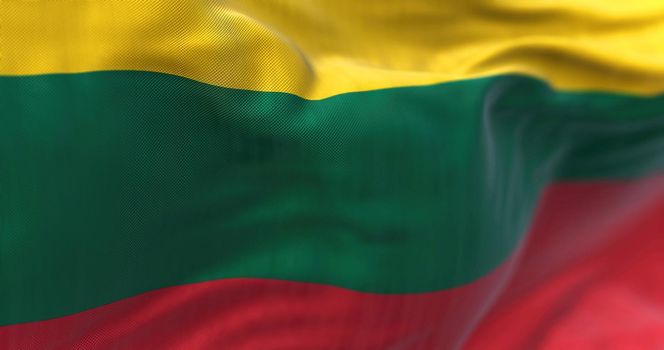 Close-up view of the lithuanian national flag waving in the wind. The Republic of Lithuania is a country in the Baltic region of Europe. Fabric textured background. Selective focus