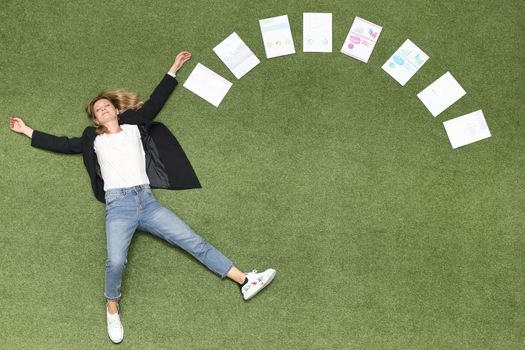 Woman is lying on green lawn along with chart business analytics. Advertising business banner place for text