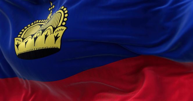 Close-up view of the Liechtenstein national flag waving in the wind. The Principality of Liechtenstein is a microstate located in the Alps. Fabric textured background. Selective focus