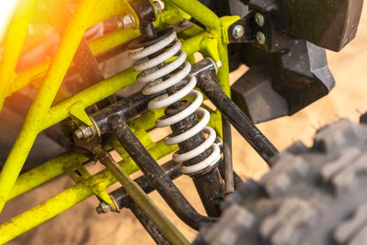 elements of the front suspension of the ATV close-up. shock absorber, spring and suspension arms. suspension ATV closeup