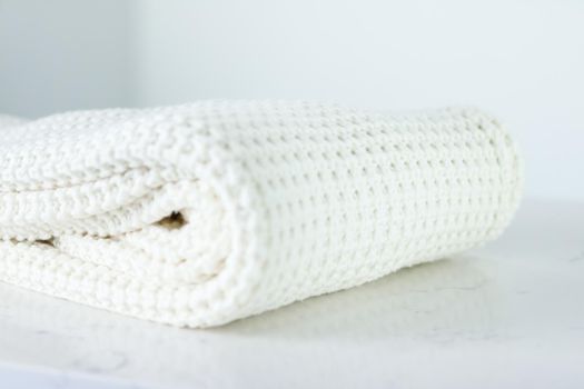 Knitwear, fabric textures and handmade items concept - Warm knitted clothes, soft and white