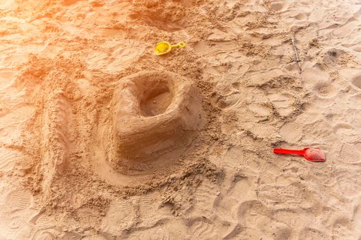 children's sand castle on the beach. a castle built by a child out of raw sand