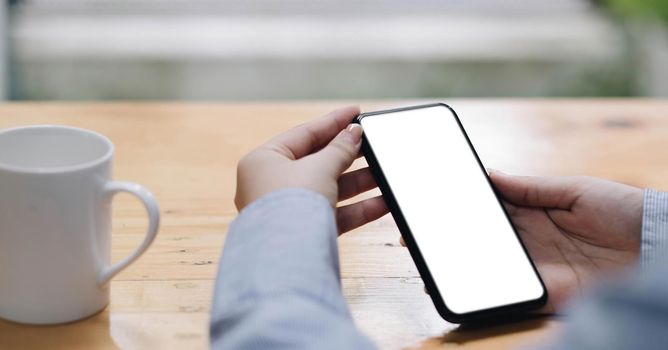 Close up of woman using cell phone,sending massages on the coffee shop.having sunbath.Phone with black screen,texting,video calls,.