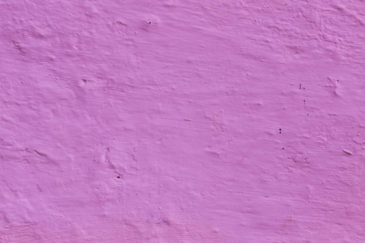 Abstract panoramic image of a purple clay wall.