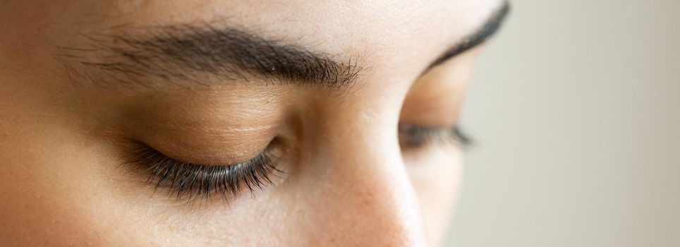 Close-up portrait of a young caucasian woman before eyelash lamination procedure