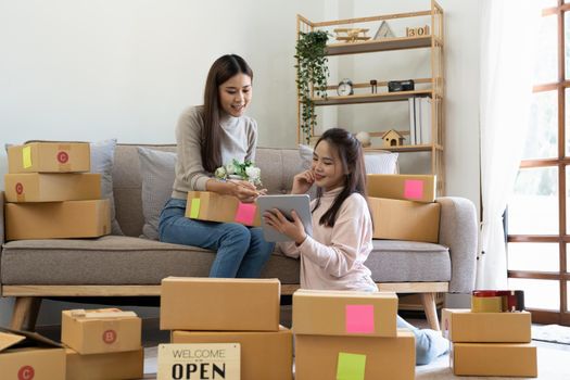 Start up small business. freelance women sellers check product order to prepare for delivery to customers. Online selling, e-commerce, shipping.