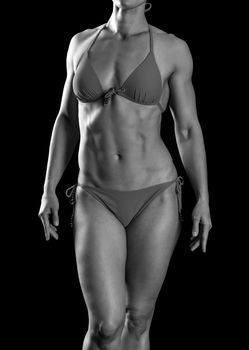Sexy sports woman in red bikini posing against black background