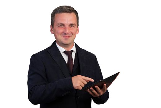 Smiling happy handsome man in a blue jacket on a white isolated background with a digital tablet looks at the camera.