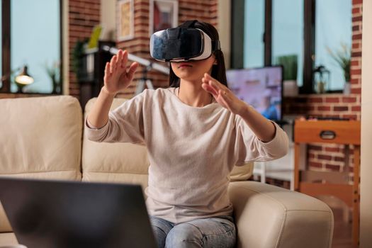 Happy asian woman enjoying wearing VR virtual reality headset, modern glasses technology headset future device gadget digital entertainment game simulation