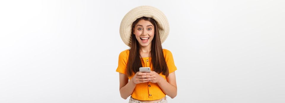 Happy young caucasian woman using smartphone standing isolated on white