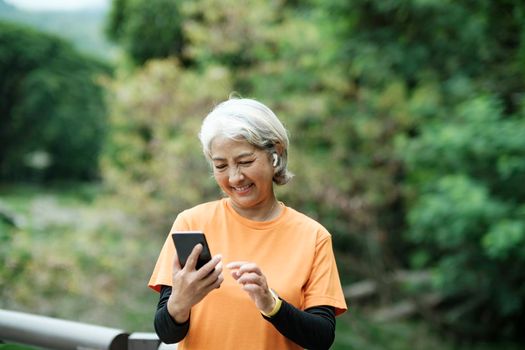 Happy senior woman taking selfie photo while before running in park. Concept of a healthy lifestyle on retirement. health concept.