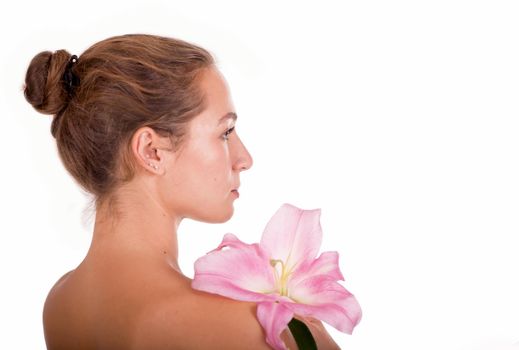 Beauty face of the young beautiful woman with flower on a white background