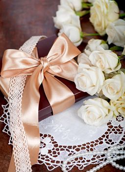 bouquet of white rose with green leaves on a wooden