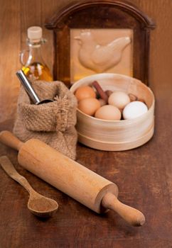 kitchen appliances, products and eggs on wooden table