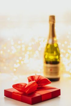 Romantic celebration, lifestyle and luxury present concept - The bottle of champagne and holiday gift box