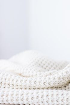 Knitwear, fabric textures and handmade items concept - Warm knitted clothes, soft and white