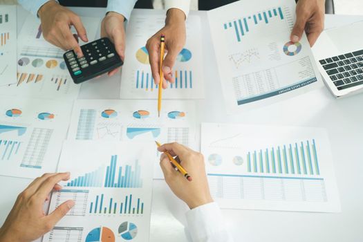 Startup asian business teamwork analyse investment marketing data on computer laptop and use calculator , finance meeting.