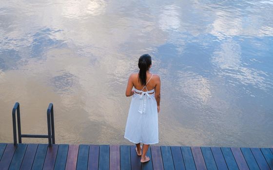 Asian women standing on the waterfront by the river, Asian women at the River Kwai