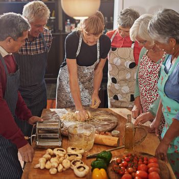 Nothing brings people together like good food. a group of seniors attending a cooking class