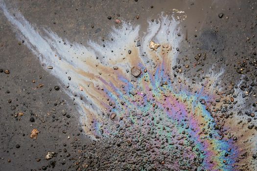 Color Gasoline fuel spots on Asphalt Road as Texture or Background. Environmental pollution concept