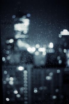 Big metropolitan city lights at night, blurry background - night life, abstract background and modern dark tones concept