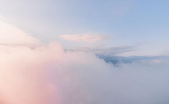 Aerial view drone flying above white clouds dense fog move quickly. Drone flies high back in blue sky through fluffy clouds. Beautiful foggy and cloudy slow moving Aerial view. Fog sea.
