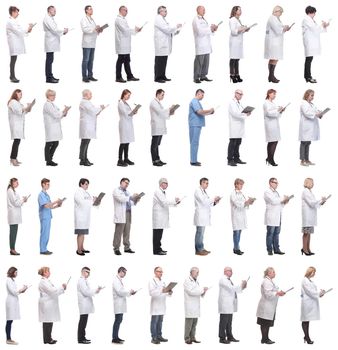 full length group of doctors with notepad isolated on white background