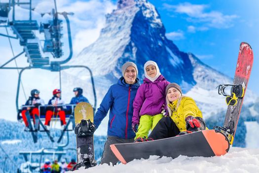 Happy family enjoying winter vacations in mountains. Playing with snow, Sun in high mountains. Winter holidays.