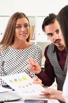 Business group of intelligent business colleagues discussing information and graphs on paper at table. Marketing growth indicators and teamwork concept