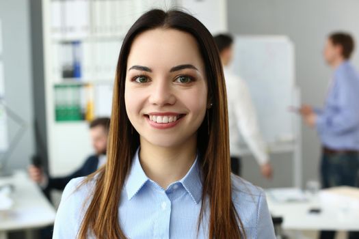 Portrait of a beautiful woman on background of business people. Young ambitious business woman to build career in consulting company