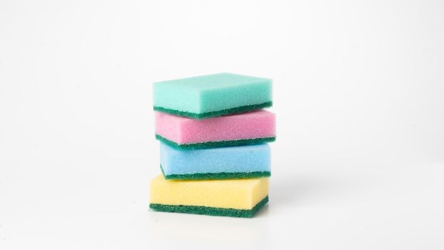 Multicolored sponges in a stack on a white background. High quality photo