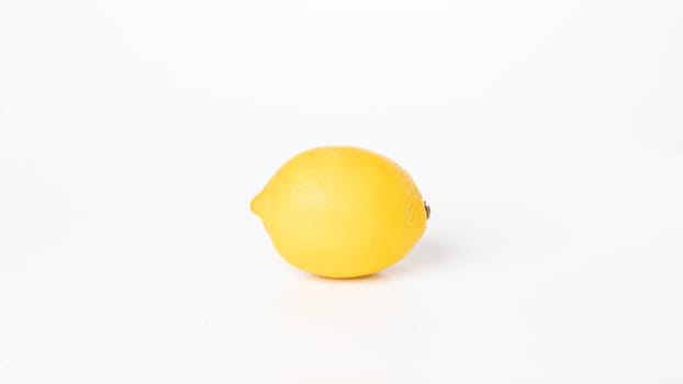 Yellow lemon on white background close-up fruits vegetables. High quality photo