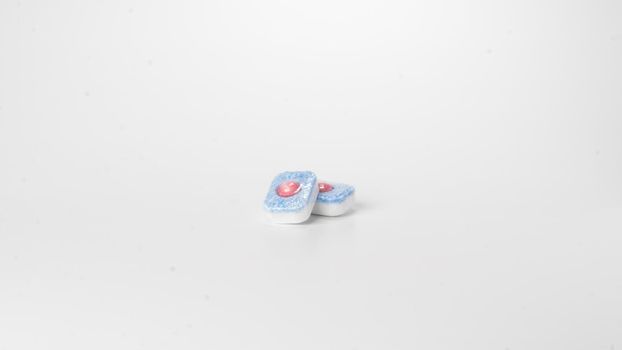 Detergent in dishwasher tablets on a white background. High quality photo