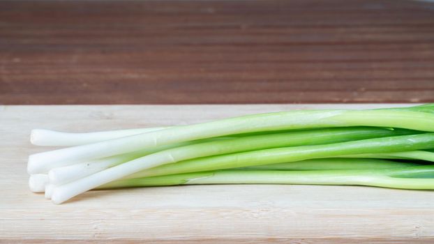 green onions feathers close-up on wooden board greenery. High quality photo