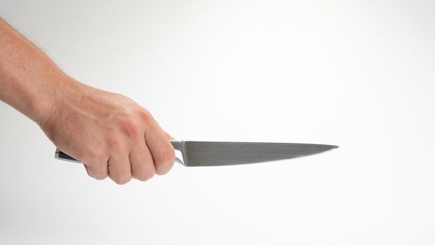 A man's right hand holds a kitchen knife gesture. High quality photo
