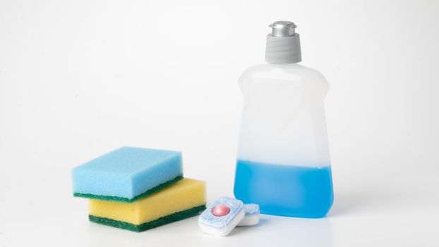 Sponges, detergent and tablets for dishwasher on a white background set for cleaning and washing. High quality photo