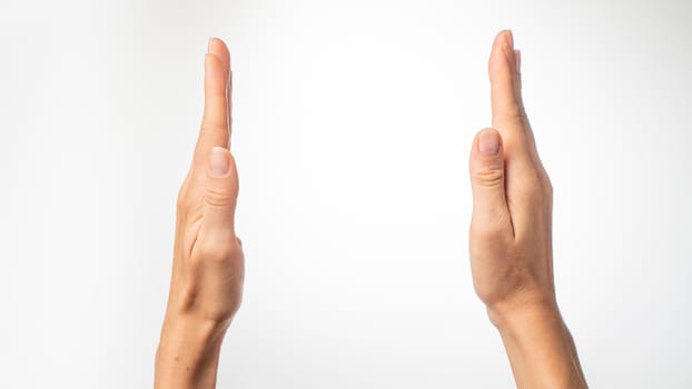 Women's hands show the distance with their palms on a white background. High quality photo